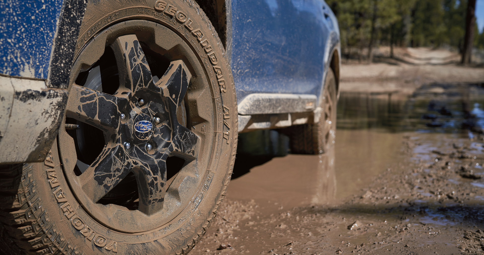A close-up of the 17-inch off-road wheels and all-terrain Yokohama GEOLANDAR® tires on the 2023 Outback Wilderness. | Valley Subaru of Longmont in Longmont CO