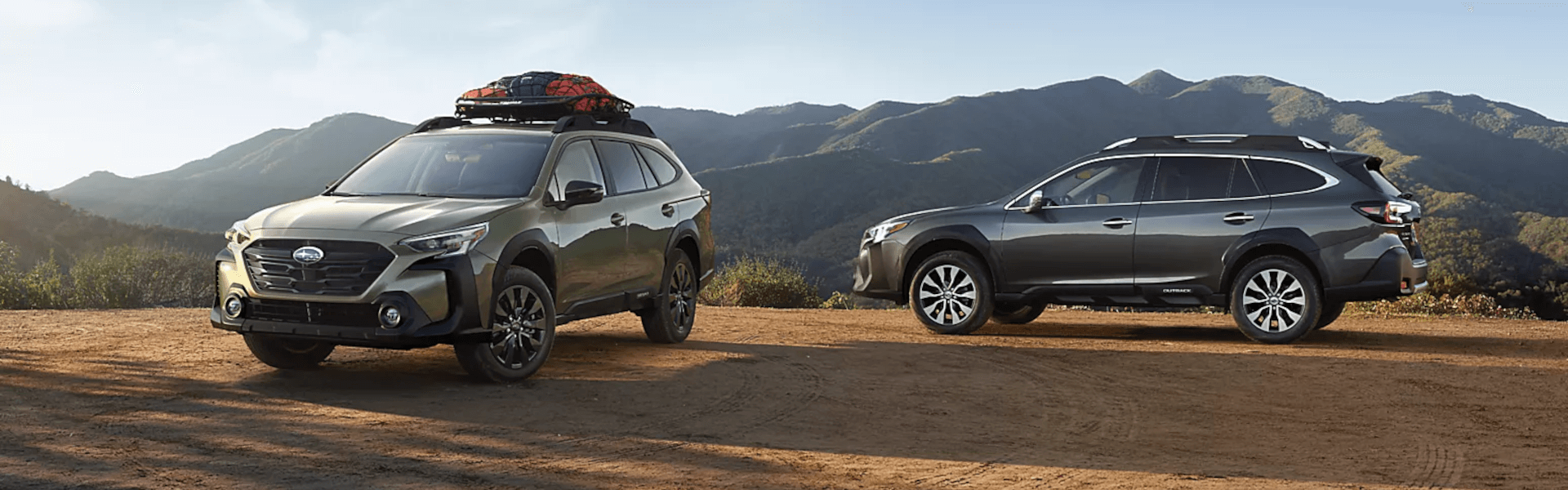 Two 2024 Subaru Outbacks on a high standing cliff