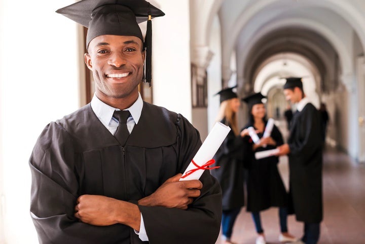 college graduate holding his diploma | Valley Subaru of Longmont in Longmont CO