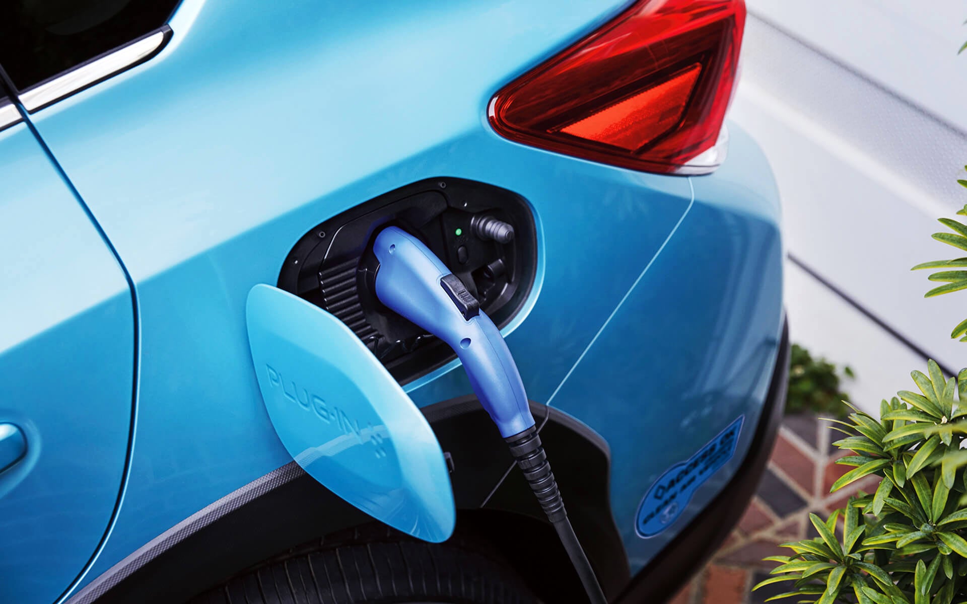 A close-up of the Subaru Crosstrek Hybrid's charging port with charging cable plugged in | Valley Subaru of Longmont in Longmont CO