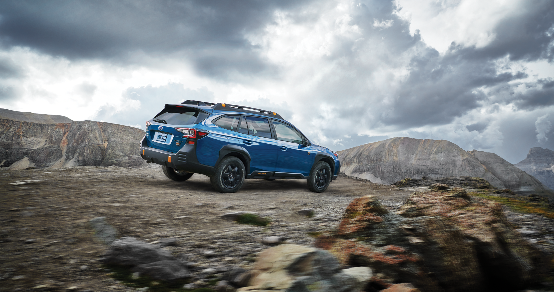 A 2023 Outback Wilderness driving on a trail in the mountains. | Valley Subaru of Longmont in Longmont CO